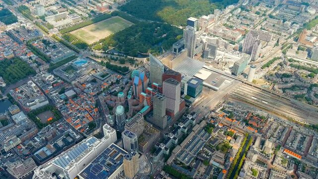 The Hague, Netherlands. Business center of The Hague. Large train station Den Haag Centraal. Cloudy weather. Summer day. Drone footage