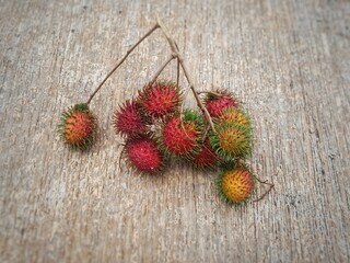 Rambutan fruit on a wooden background