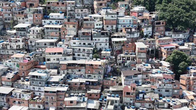 Aerial drone view of Favela Of Cantagalo, Rocinha favelas spread out on the mountain in Sao Conrado , Rio de Janeiro, Brazil.