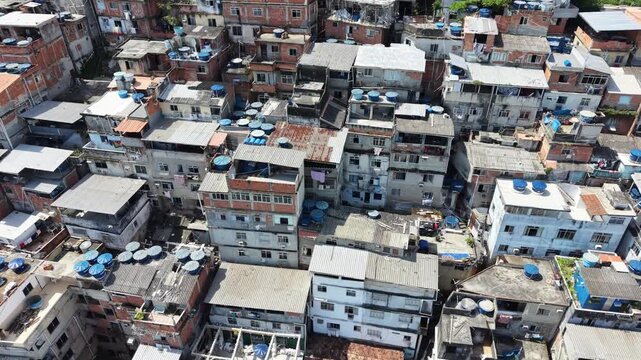 Aerial drone view of Favela Of Cantagalo, Rocinha favelas spread out on the mountain in Sao Conrado , Rio de Janeiro, Brazil.