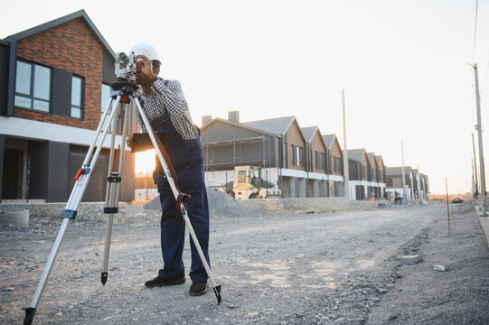 Surveyor working on new residential construction site