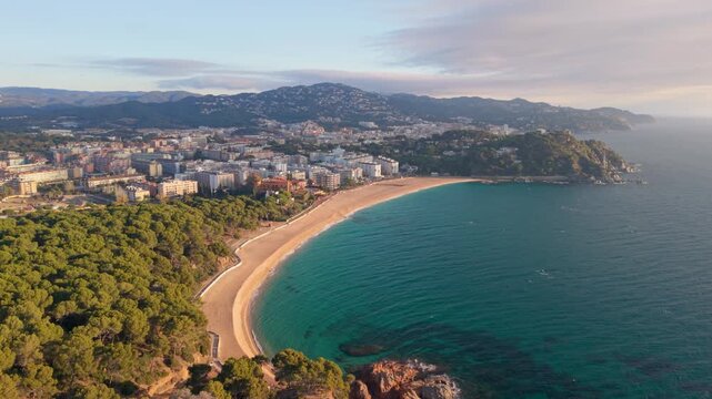 Costa brava breathtaking aerial footage capturing the stunning coastline of lloret de mar. The tranquil turquoise sea gently washes over the golden beach. Boadella lloret de mar