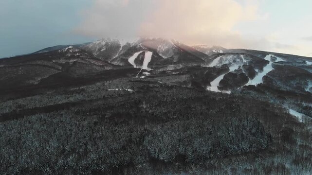 Aerial establishing at summit of Mount Iwaki Tsugaru Fuji snowed Japan mountain, Aomori natural landscape