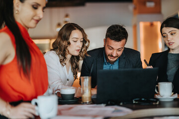 A group of colleagues gathers around a laptop at a cafe-style meeting, sharing ideas and taking notes. Warm drinks and a relaxed atmosphere convey teamwork, focus, and professional collaboration.