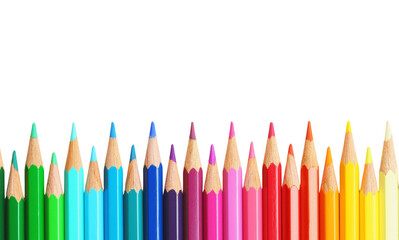 Colorful array of pencils arranged in a vibrant rainbow pattern on a white background