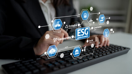 A business professional engaged in analyzing the concept of Environmental Social Governance (ESG) with digital icons, emphasizing sustainability and corporate responsibility. Tessel