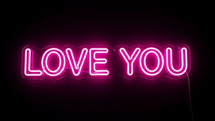 Obraz premium A neon sign displays LOVE YOU in pink letters against a dark background.