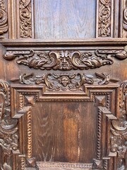Ornate Antique Wooden Carving Detail.
Detailed antique wooden panel with decorative carvings and classic ornamental craftsmanship texture.