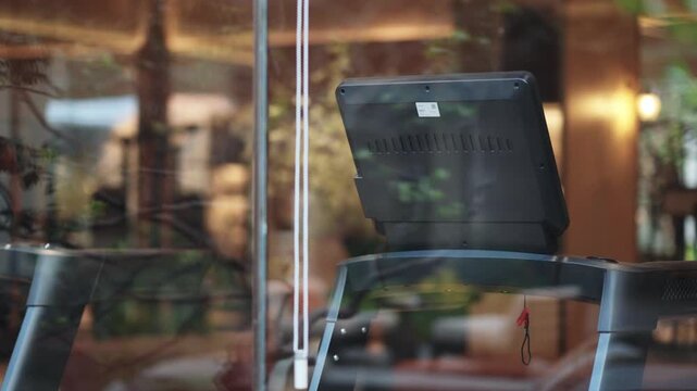 Fitness machine with screen by window