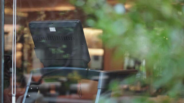 Fitness machine with screen by window