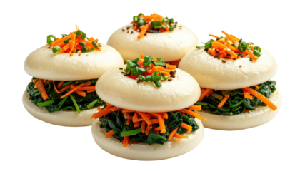 Four steamed buns filled with vibrant greens, shredded orange vegetables, topped with chopped herbs and black seeds