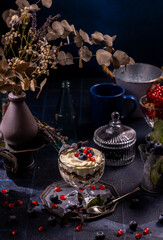 Dessert parfait with blueberry, pomegranate and cream topping