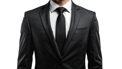 A person, likely male, is shown from the chest up, smartly dressed in a dark suit with a black tie and a crisp white shirt. The background is a gradient