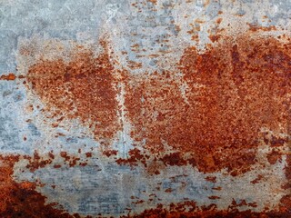 the roof of the house is made of used and rusty zinc