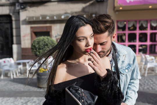 Smoking couple in city outdoors with sunset afternoon light