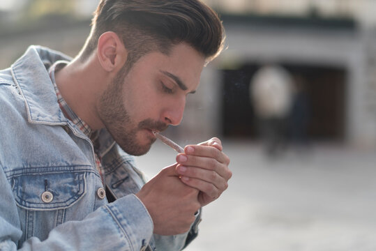 man smoking cigar in the city
