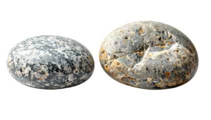 Two oval, rounded stones sit against a stark black background, showcasing intricate textures. Their surface reflects various colors, details revealed