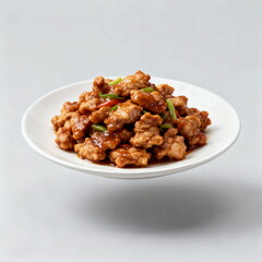 Delicious fried pork pieces in savory sauce with green onions