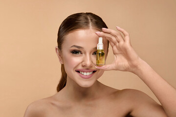 Portrait of beauty woman holding serum in studio for skincare treatment and healthy glow on face