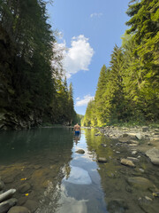 Person Wading in a Serene Forest River Copy Space