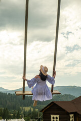 Woman Swinging Over Scenic Carpathian Mountain Landscape