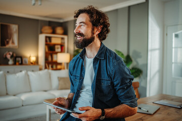 Man freelancer using tablet working from home