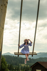 Woman Swinging Over Scenic Carpathian Mountain Landscape