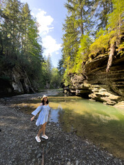Woman Strolling by River in Forest Copy Space