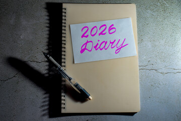 A notebook with '2026 Diary' handwritten and a pen.