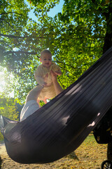 Parent and Baby Enjoying Hammock Time Outdoors Copy Space