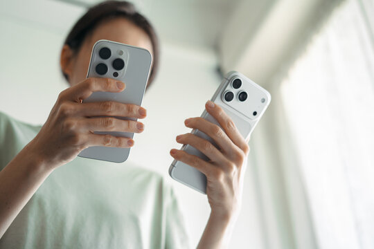 Woman comparing iPhone 16 Pro and iPhone 17 Pro Max