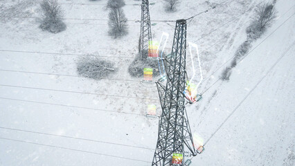 Snowy aerial power grid with animated full battery, symbolizing energy distribution and stability during cold seasons