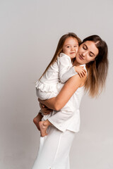 a newborn baby in its mother's arms, the mother soothes the baby before bedtime by rocking it to sleep