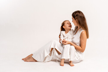 a newborn baby in its mother's arms, the mother soothes the baby before bedtime by rocking it to sleep