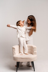 a newborn baby in its mother's arms, the mother soothes the baby before bedtime by rocking it to sleep