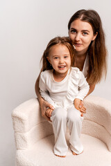 a newborn baby in its mother's arms, the mother soothes the baby before bedtime by rocking it to sleep