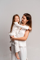 a newborn baby in its mother's arms, the mother soothes the baby before bedtime by rocking it to sleep