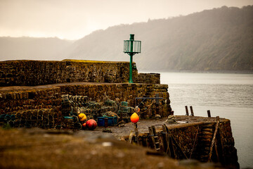 Fishing harbour with lobster pots and navigation light in Clovelly, Devon, England