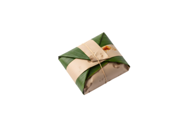 Nasi lemak featuring a mix of spicy sambal sauce and crunchy fried anchovies, all carefully wrapped in paper and banana leaf.

