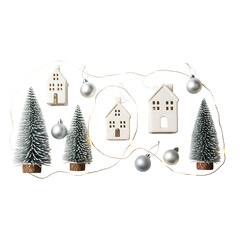 White ceramic houses and miniature pine trees with silver ornaments and fairy lights