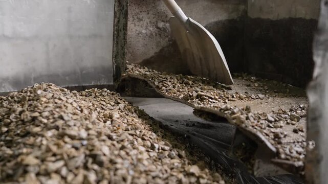 Industrial equipment sorting raw materials. A vibrating screen separator machine sorting crushed stone for processing in a quarry or factory