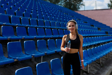 sporty young woman with an athletic figure with a bottle of water	
