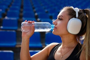 sporty young woman with an athletic figure with a bottle of water	
