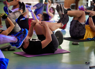 Sporty people exercise with weights in workout class. Healthy lifestyle, sport, workout concept