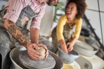Close up on hands making pot from clay on pottery modeling workshop. Creative, hobby ,activities concept