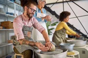 beginner man shaping clay on pottery course. Creative, hobby ,activities concept