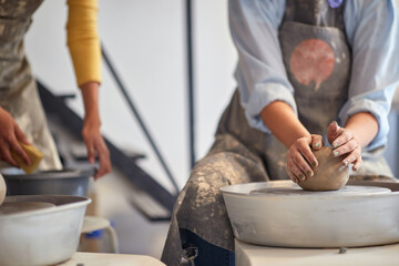 Woman shaping clay with hands on pottery workshop. Creative, hobby ,activities concept