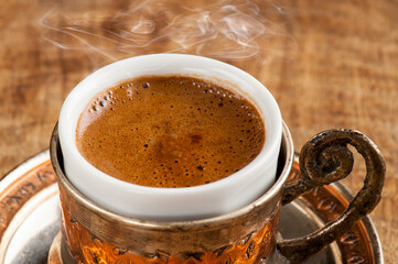 Traditional Turkish Coffee with steam in Copper Holder