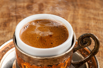 Traditional Turkish Coffee with steam in Copper Holder