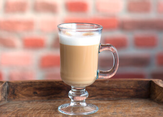 Latte Macchiato in Glass Mug on Wooden Tray